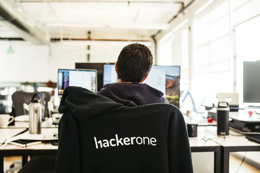 employee reading a screen sitting at desk