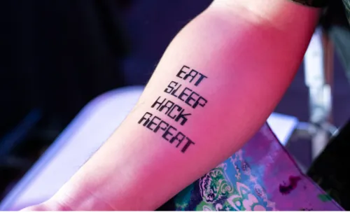 A tattoo on an ethical hacker that reads "Eat, Sleep, Hack, Repeat"